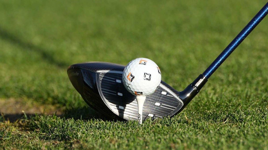Driver and golf ball at address on the tee